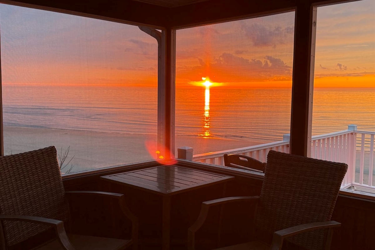 Enjoy a stunning sunset from the comfort of this elegant screened-in porch. It provides the perfect luxury setting to relax and take in breathtaking, panoramic bay views.
