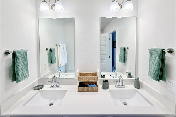Primary bathroom with dual vanities. A selection of toiletries is provided by us