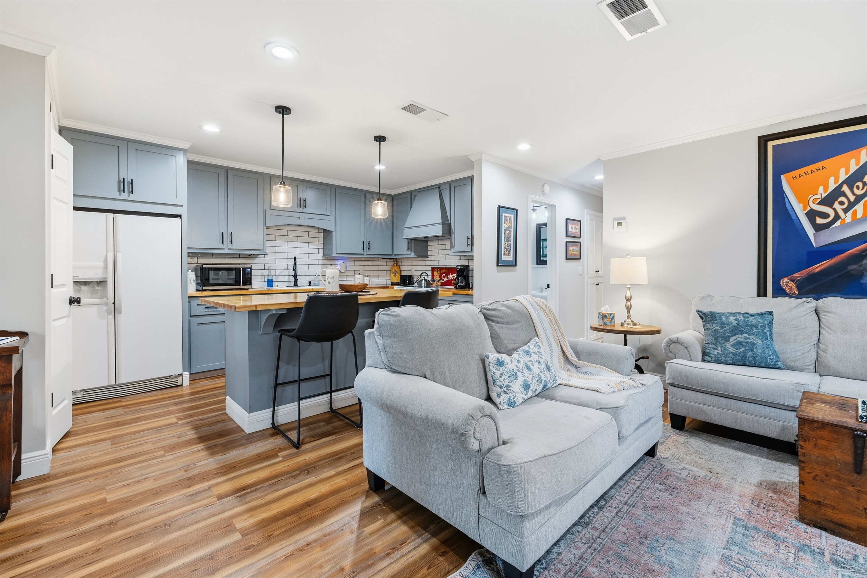A fresh, fully equipped kitchen with island seating—perfect for quick bites or slow mornings.
