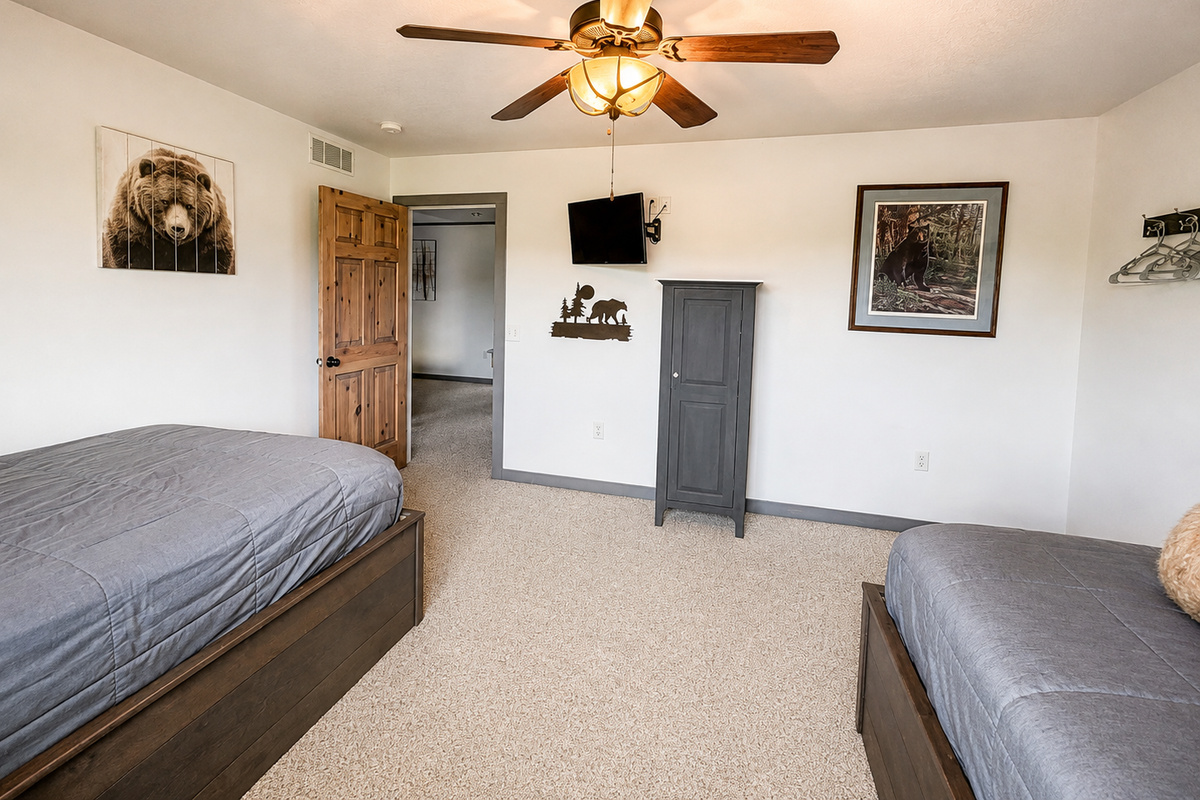 Bedroom highlights the wall-mounted TV, perfect for winding down with a favorite show after a full day of Northwoods adventures before settling in for the night.