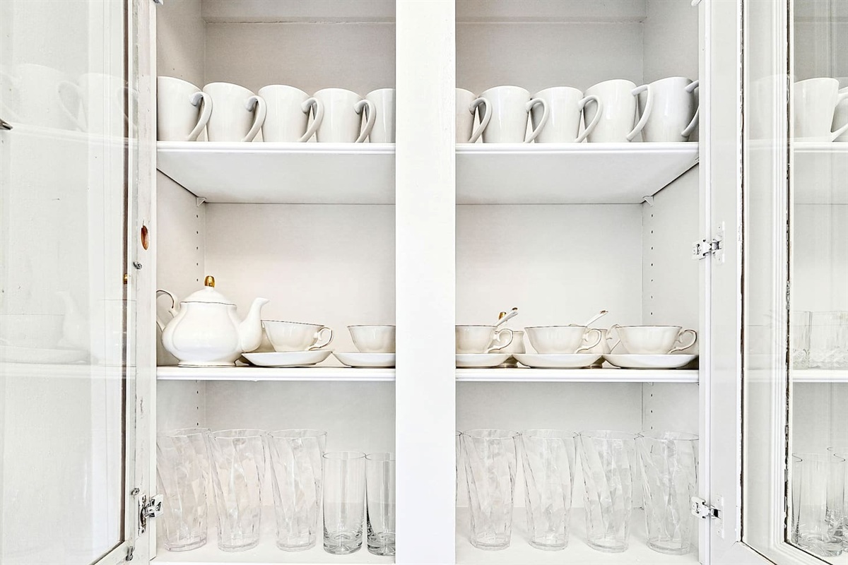 Bright and beautifully designed kitchen with white marble counters and white wood cabinetry. Fully equipped and ideal for cooking, gathering, and hosting with ease.