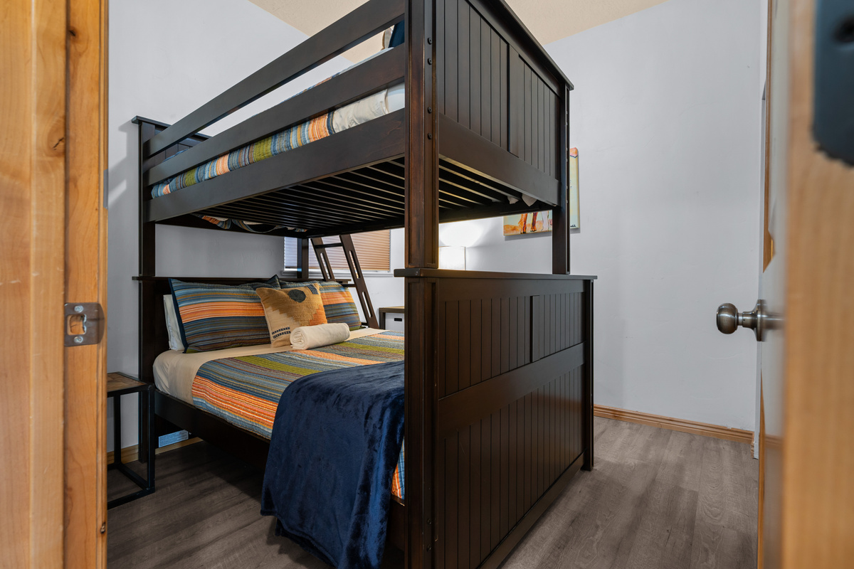 Perfect for kids or extra guests, this cozy bunk room features a twin-over-full bunk bed in a comfortable and inviting space.