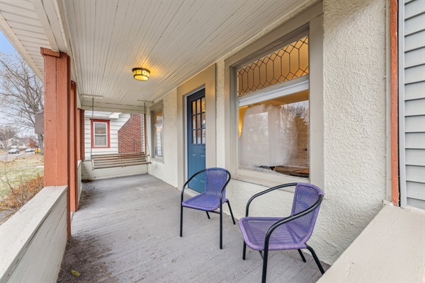 Lovely open porch with swing and seating area