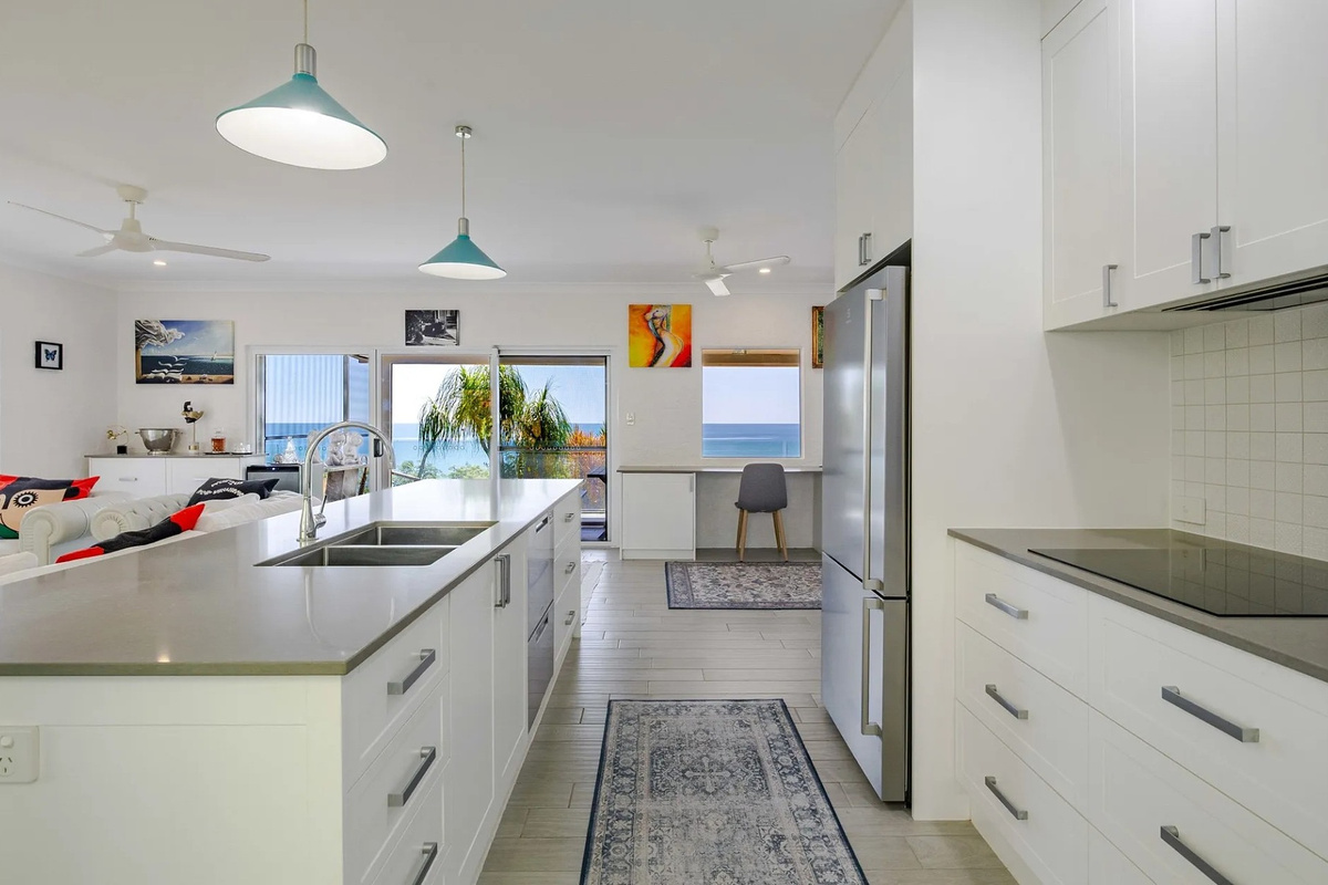 The kitchen includes a long island bench, full-size fridge, cooktop and open connection to the lounge, deck and study nook.
