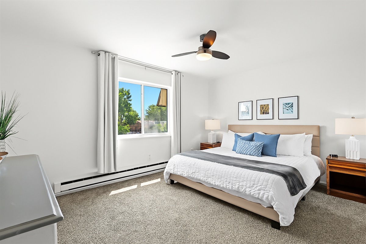 Experience restful luxury in this serene retreat, featuring a king bed and a sleek modern wood accent wall.