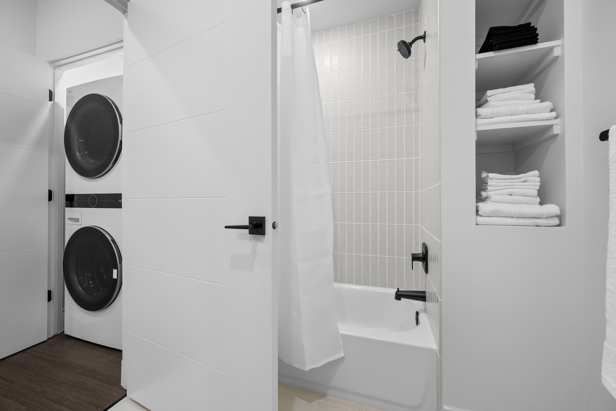 Fresh towels and modern finishes throughout the bathroom.