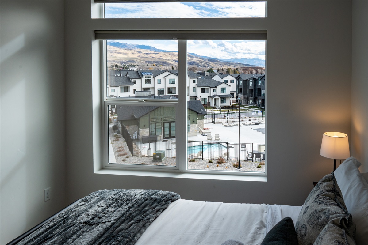 Upstairs bedroom with window overlooking the beautiful pool area.