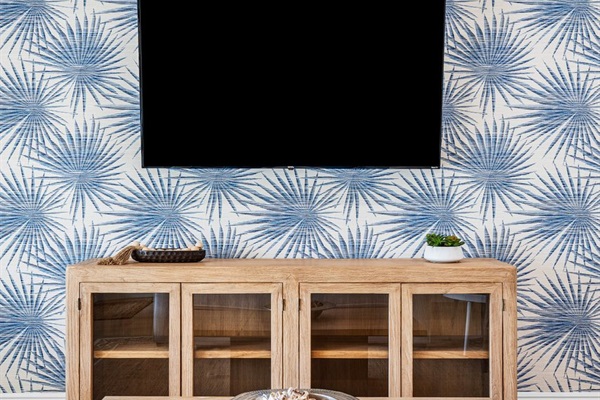 Movie nights feel elevated with this sleek entertainment setup, blending contemporary design with a relaxed beach house vibe.