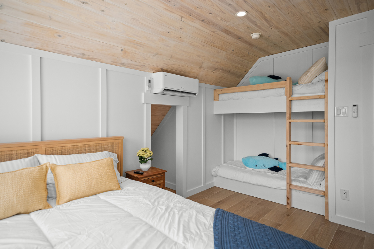 Queen bedroom with a built-in bunk bed for flexible family sleeping.