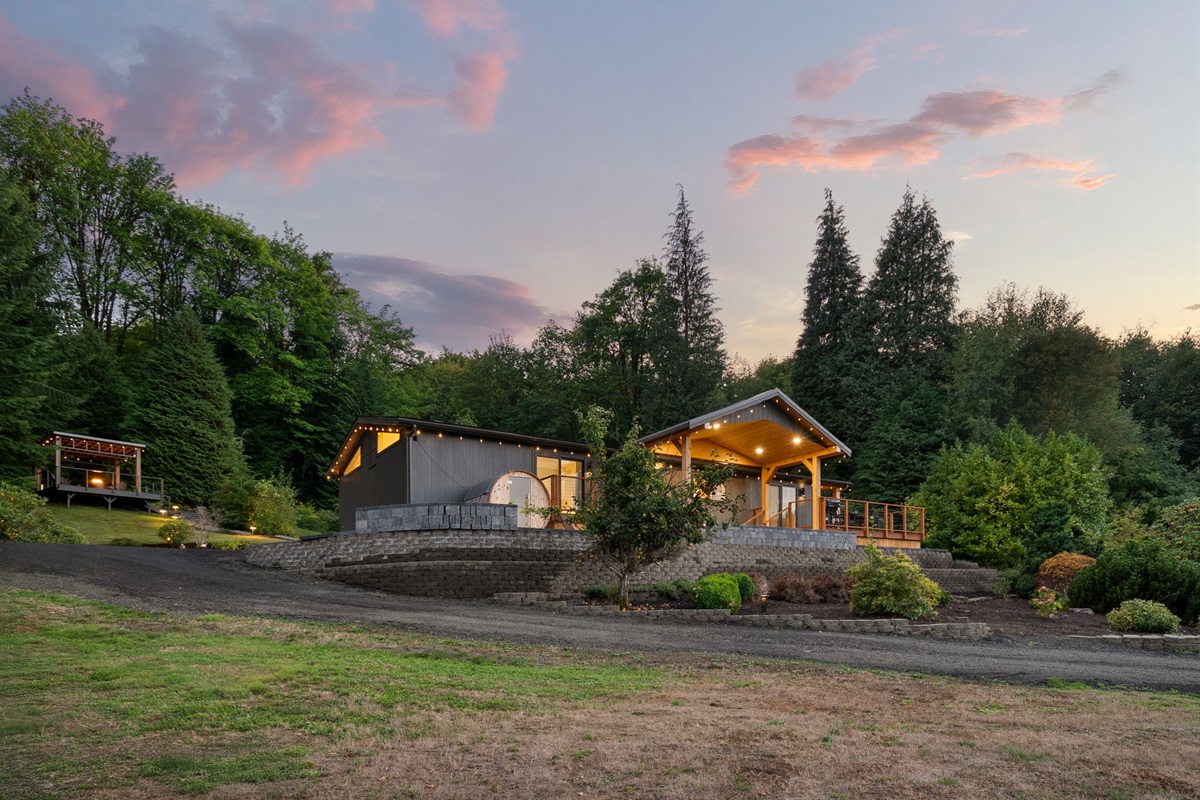 The glowing home feels like a comforting haven nestled within open, tranquil land