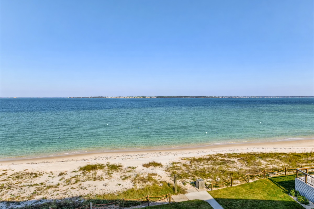 End the day with a peaceful beach view, where the calm water meets the horizon.