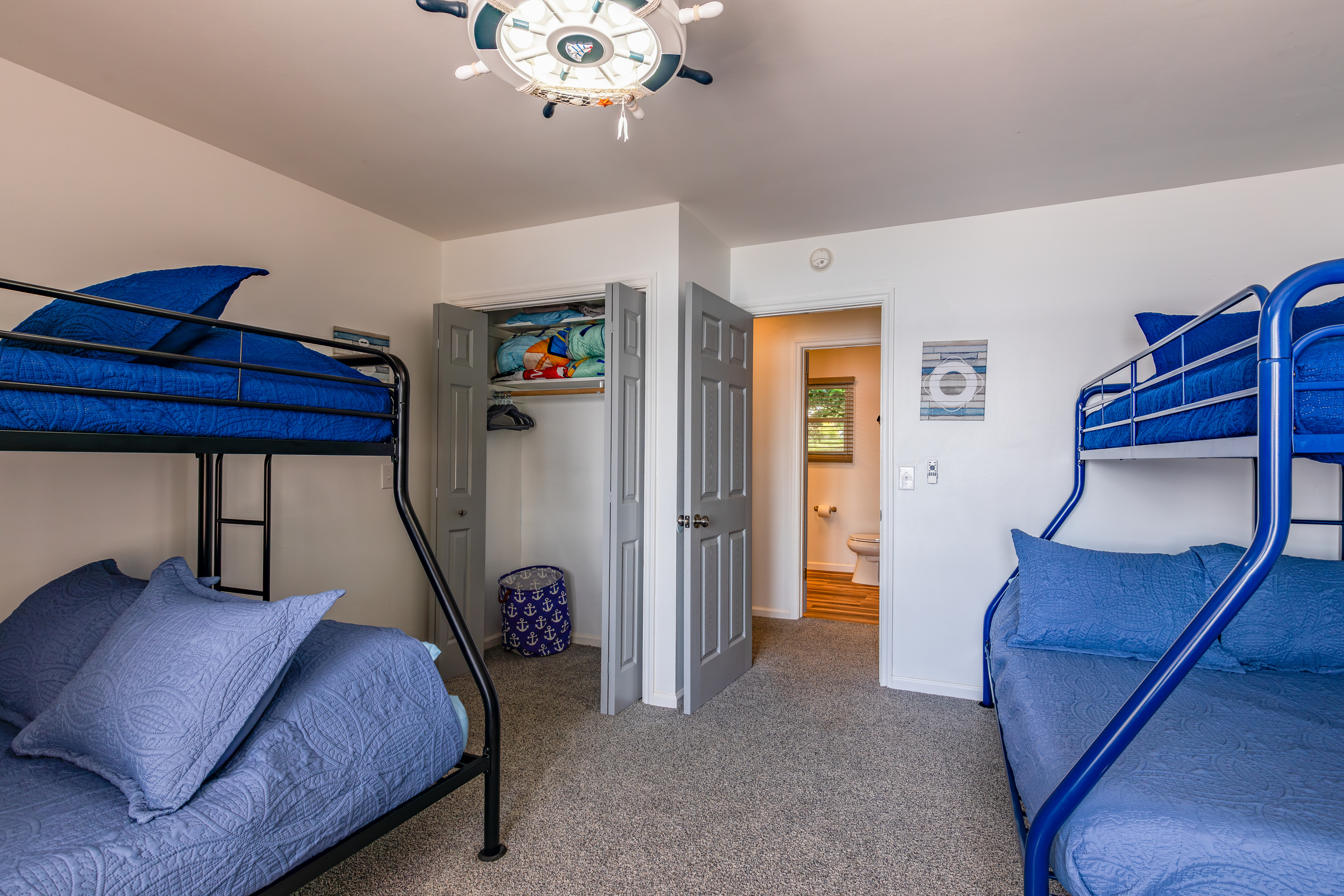 A second bunkroom view shows the closet storage and nearby bathroom access.