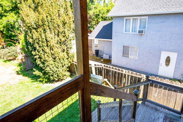 Back patio and stairs down to yard. 