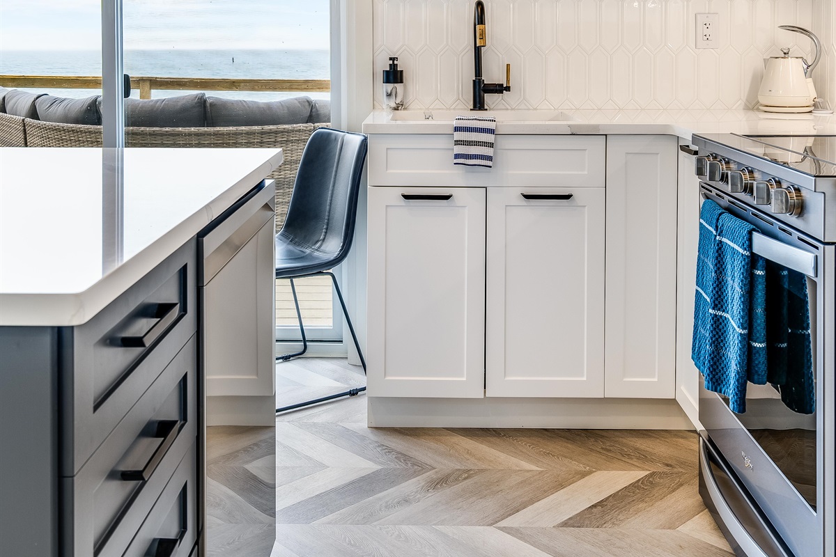 Fully equipped kitchen with stainless steel dishwasher and electric stove/oven combo.