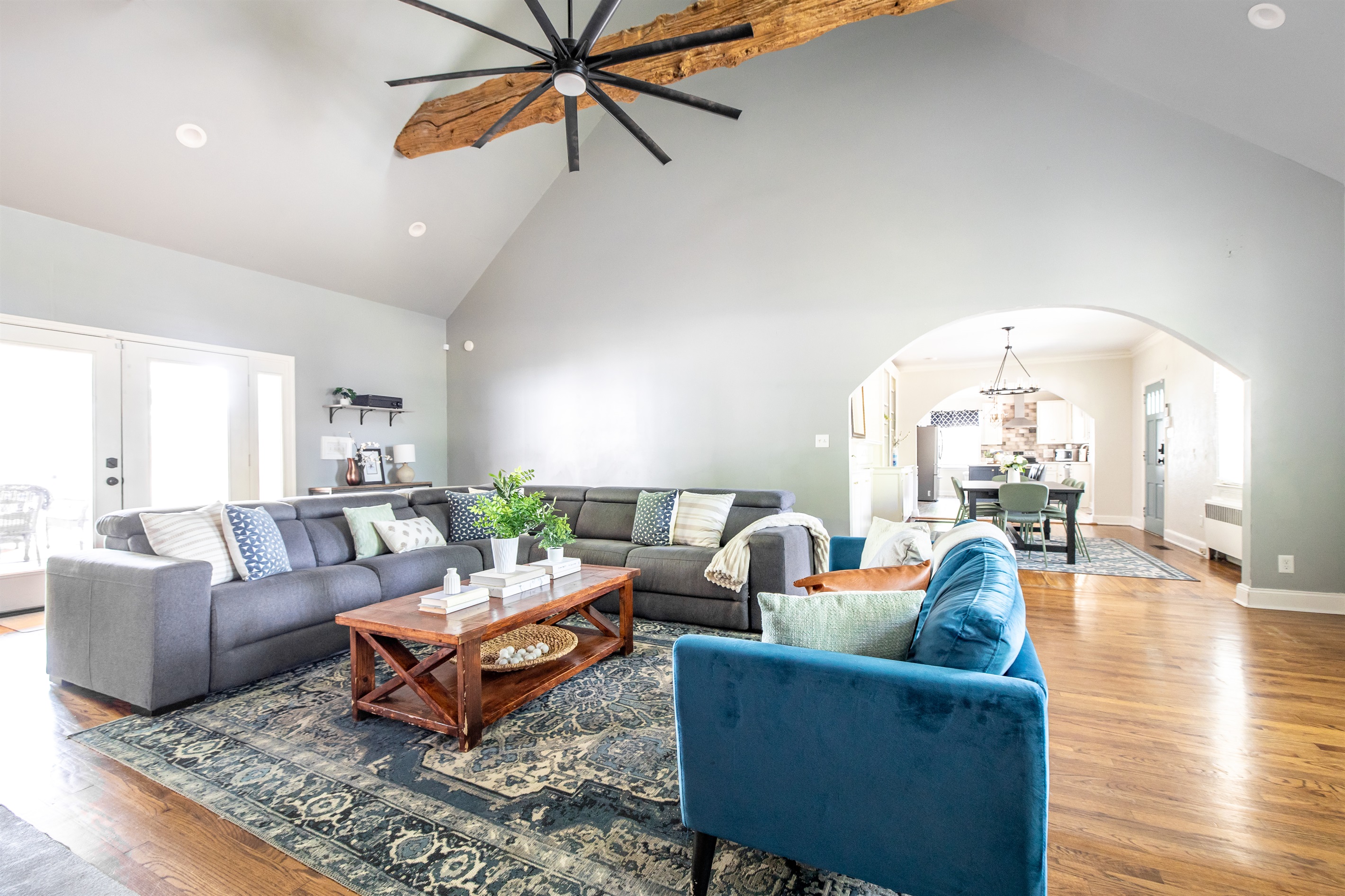 Spacious living room with vaulted ceilings, game table, TV