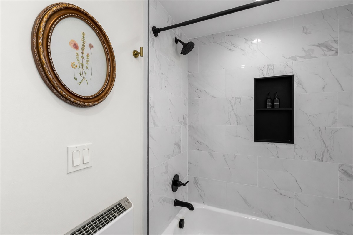 Sleek, spa-inspired shower with modern fixtures, elegant tile, and built-in storage—perfect for refreshing mornings or unwinding after a long day.