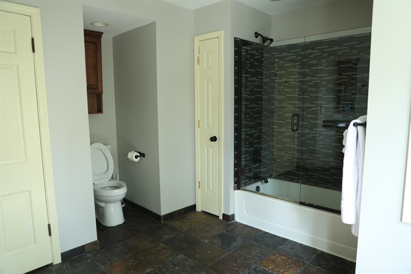 2nd Floor large full bathroom showing toilet, linen closet, shower/tub, and radiant heated flooring