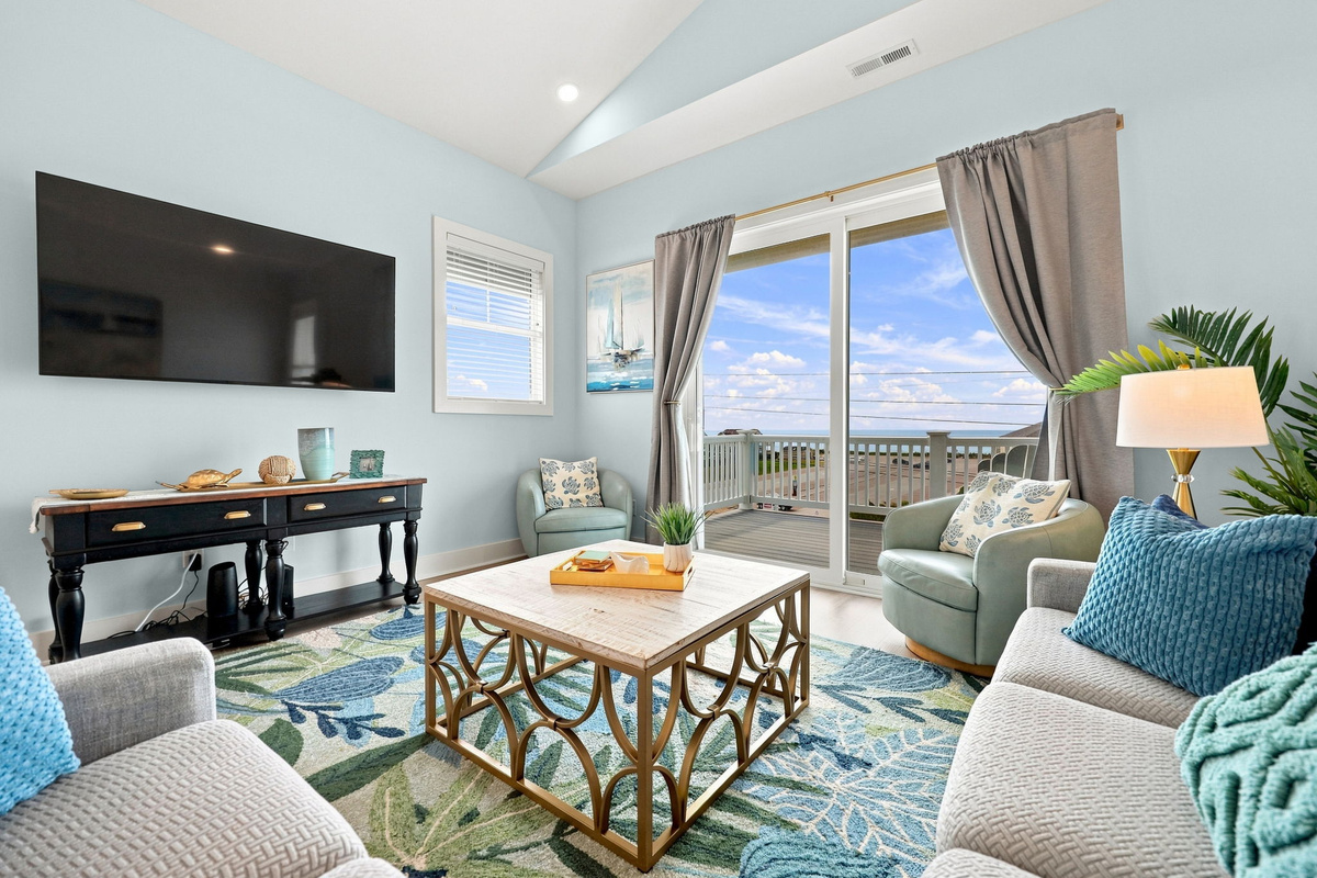 Unwind in the bright and inviting living space featuring coastal-inspired d&eacute;cor, comfortable seating, and beautiful views that bring the Emerald Isle charm indoors