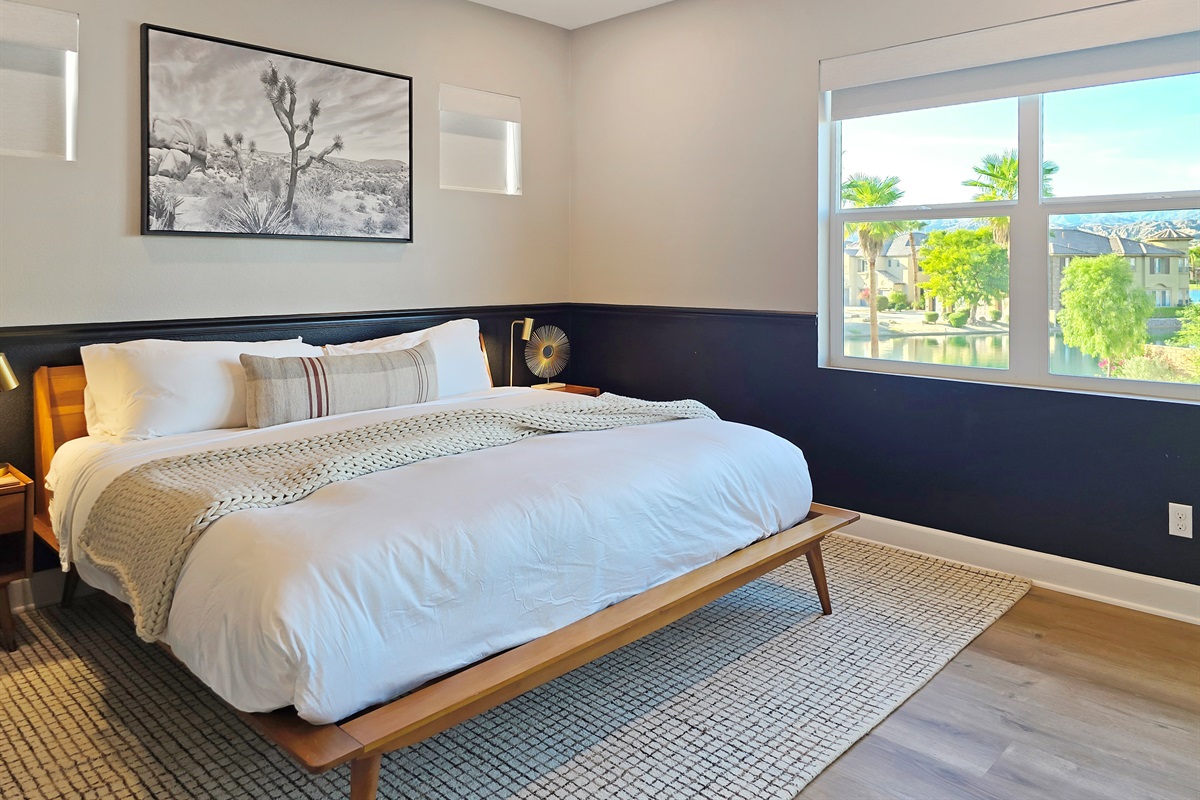 Bedroom #2 upstairs features a king-sized bed, lake views, ceiling fan, smart TV, closet and an ensuite bathroom with bathtub/shower combo. (Sleeps 2)