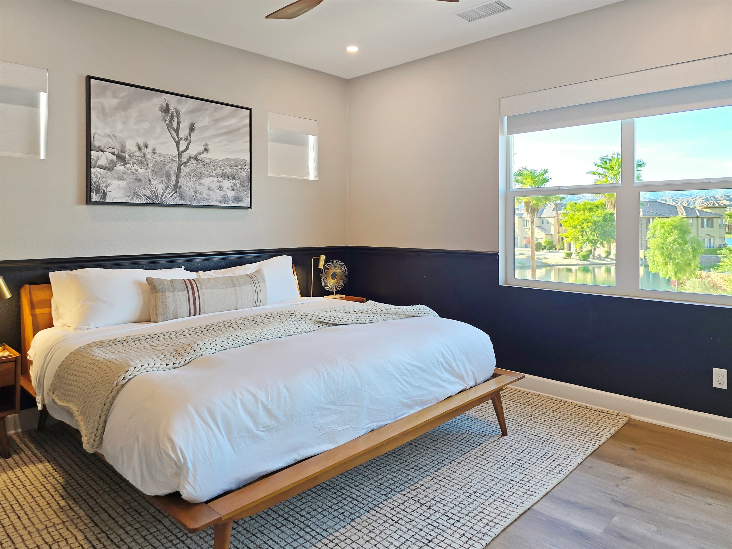 Bedroom #2 upstairs features a king-sized bed, lake views, ceiling fan, smart TV, closet and an ensuite bathroom with bathtub/shower combo. (Sleeps 2)