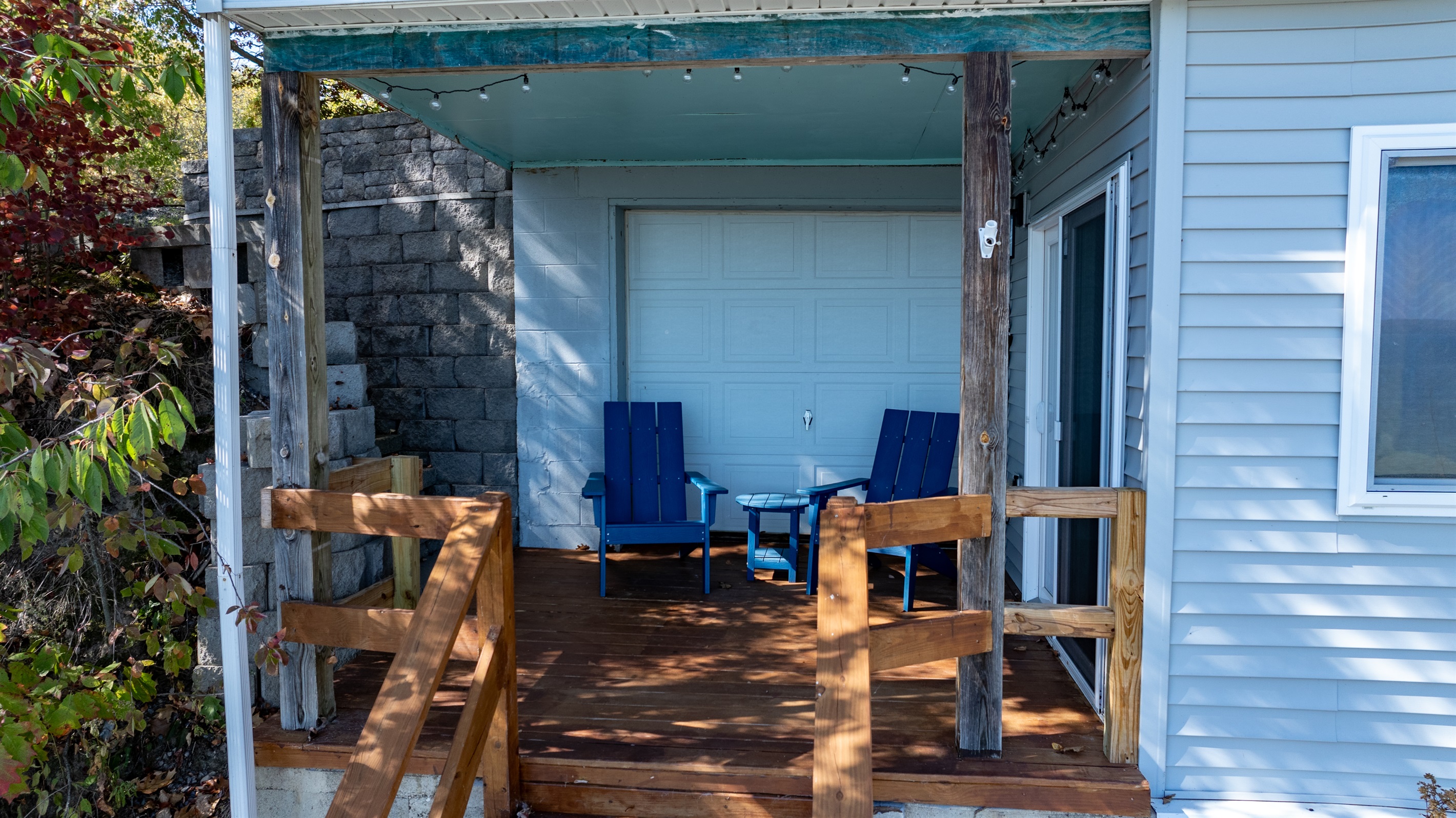 Relax on the covered porch with cozy seating and lake breezes — the ideal spot to unwind after a day on the water.