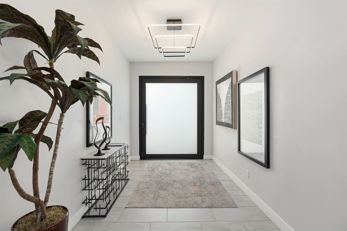 Clean lines and geometric light fixtures make a striking first impression in this modern entry hall.