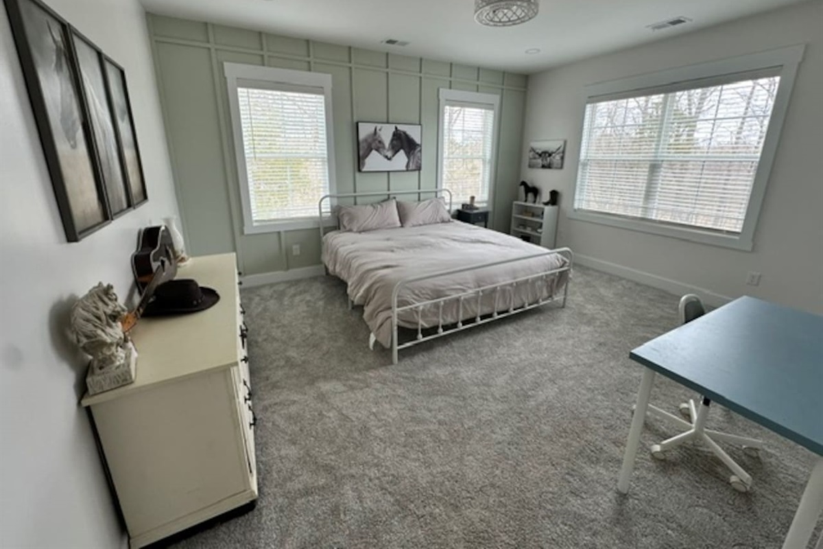 Welcome to Kentucky! This western-themed room is definitely a taste of the bluegrass. Private sink and makeup vanity with shared access to private toilet and shower with bedroom #4. Desk and chair available.