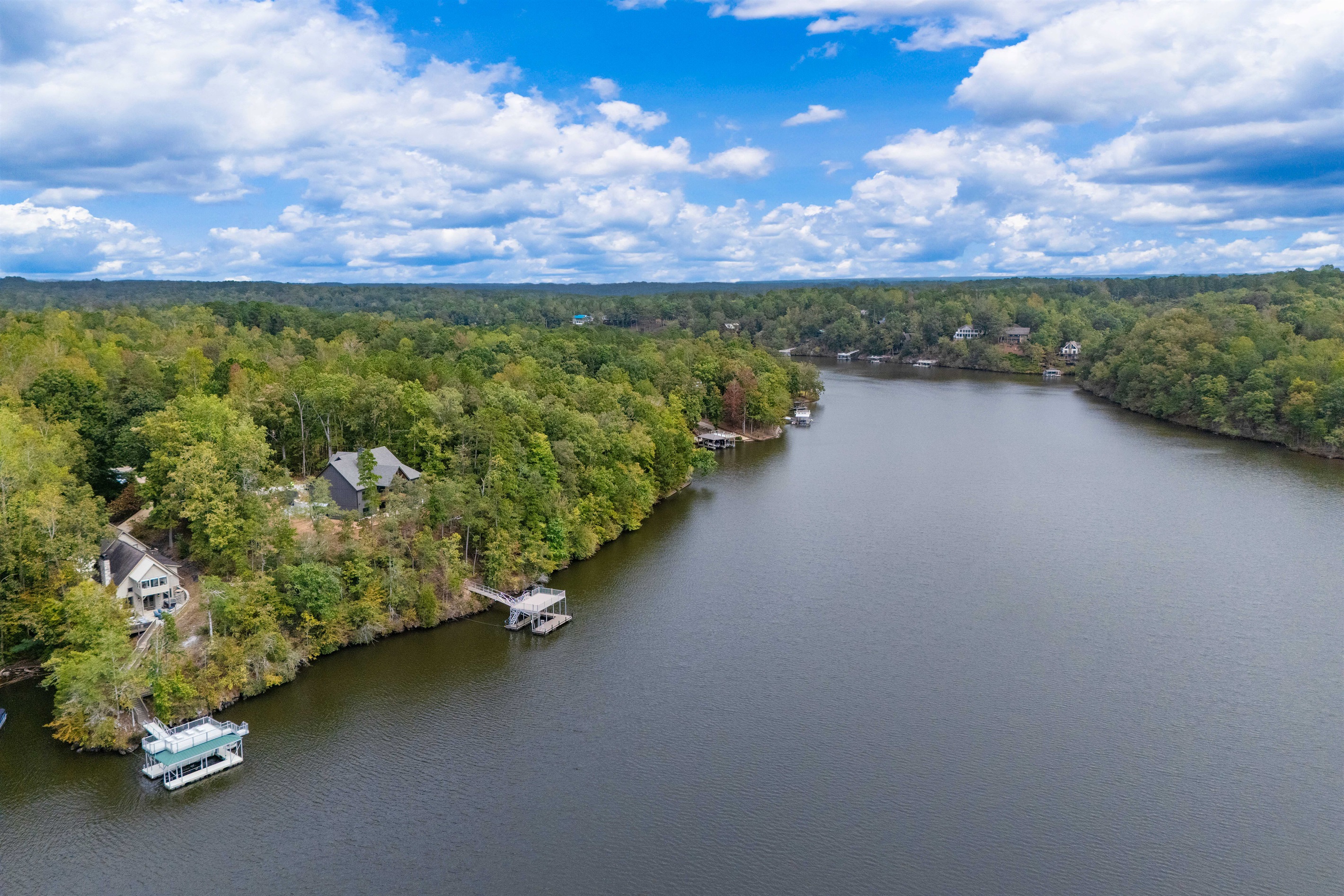 The aerial view of the lake highlights its expansive beauty and peaceful surroundings, showcasing the perfect setting for your lakeside getaway.