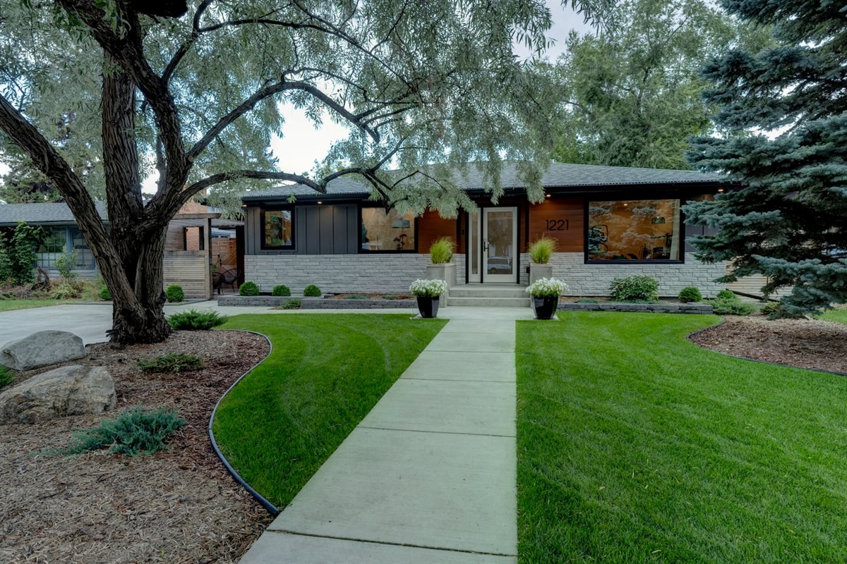 Exterior of the home where the suite is located, set on a quiet, tree-lined residential street.
