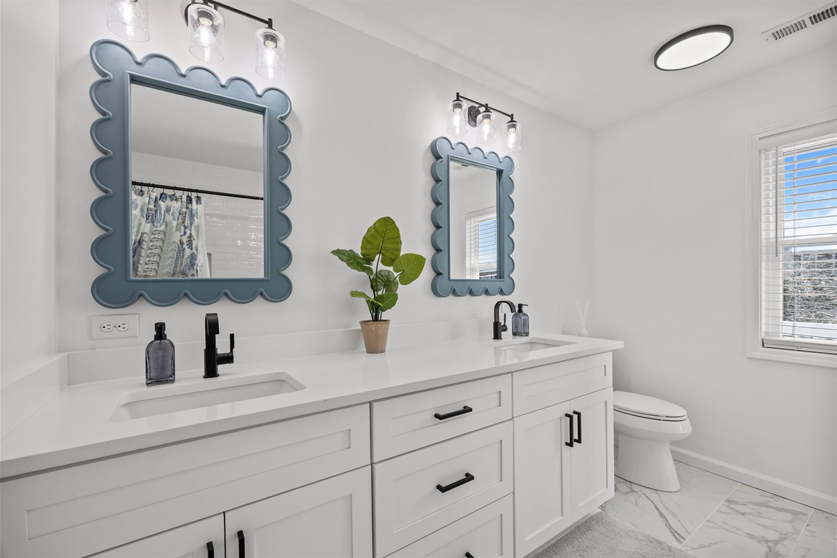 Bright and clean second floor bathroom with double sinks and plenty of space