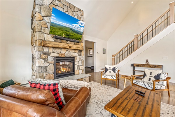 Warmth and ambiance await by the fireplace.