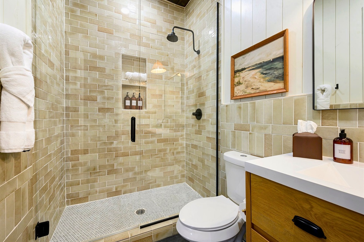 Soft, earthy tones make this bathroom feel warm and calming, complete with a lovely tiled shower.