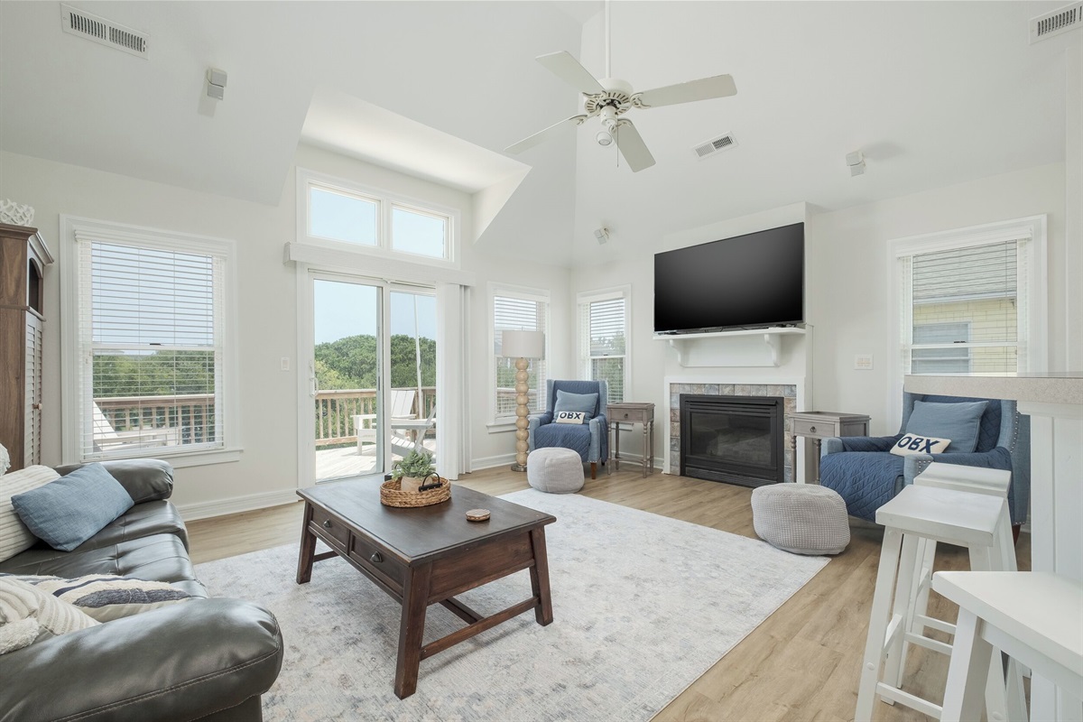 Bright and airy living area with high ceilings and cozy seating.