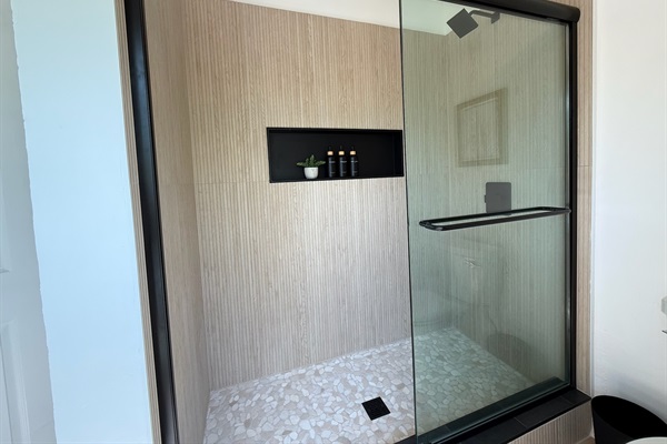 Modern beachy shower in the main level master bathroom. Lots of natural light from the oversized window