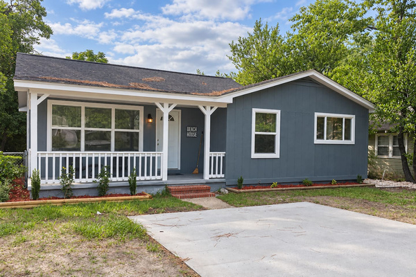 Beach House Exterior: Charming retreat with coastal vibes and inviting porch for sunny days!