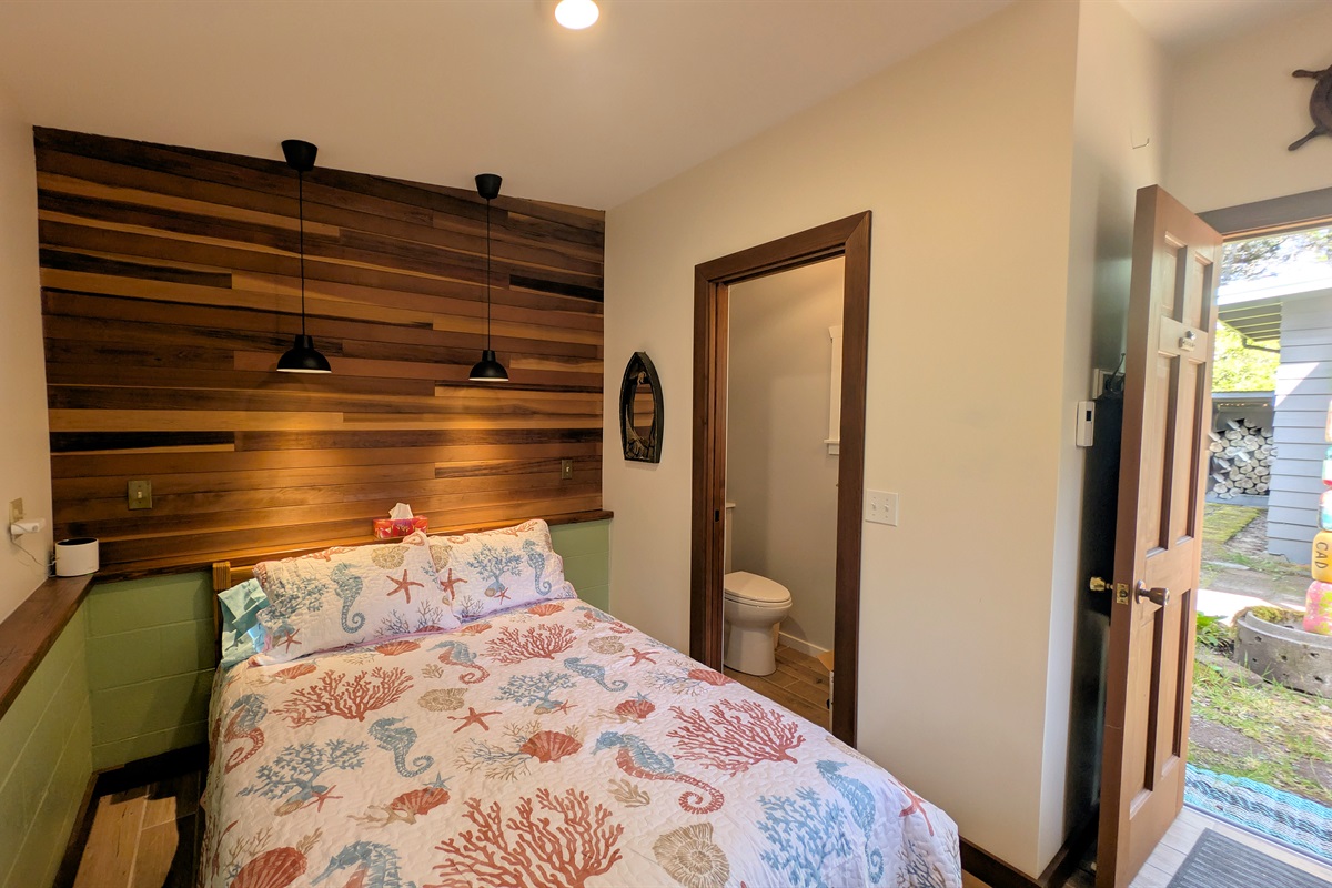 full size bed in bunkhouse with attached bath