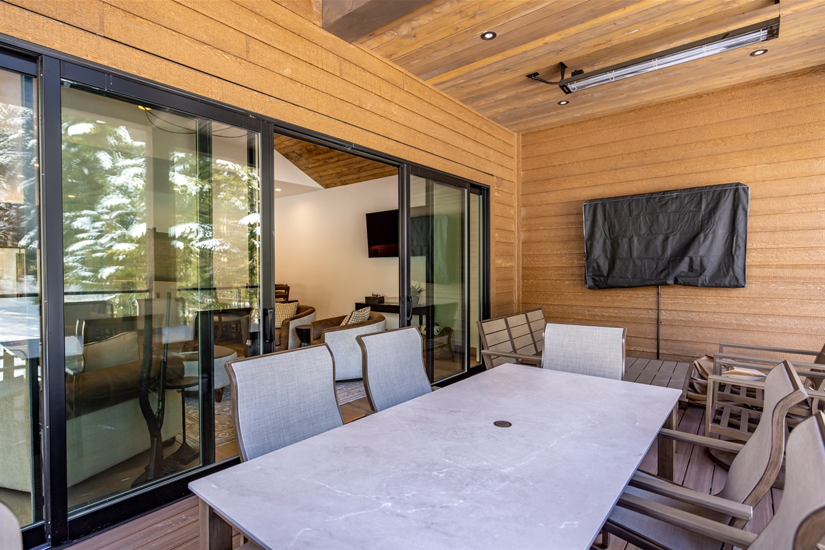 Back deck with a TV, heaters for the winter chill, fans for the summer heat, a bar-b-q, and a flat top!
