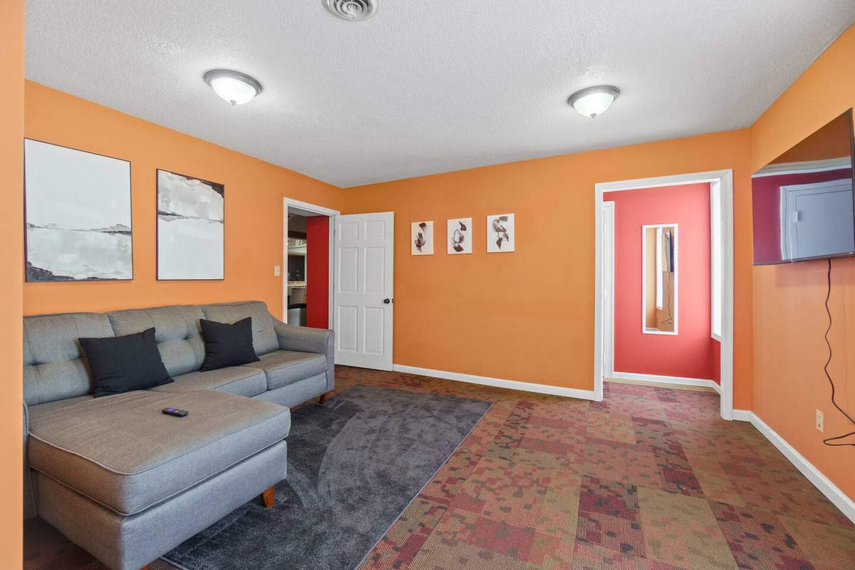Bedroom featuring extra couches, adding extra comfort and seating for a relaxed, cozy atmosphere.