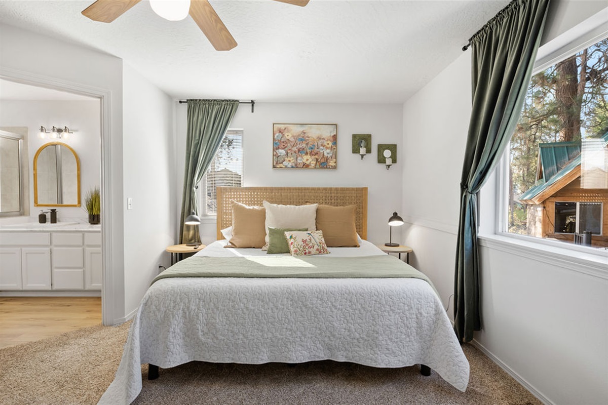 Bedroom #1 is Primary Bedroom with a King Size bed, attached ensuite with built in  jacuzzi whirlpool tub, as well as dresser, walk in closet, smart tv and desk.