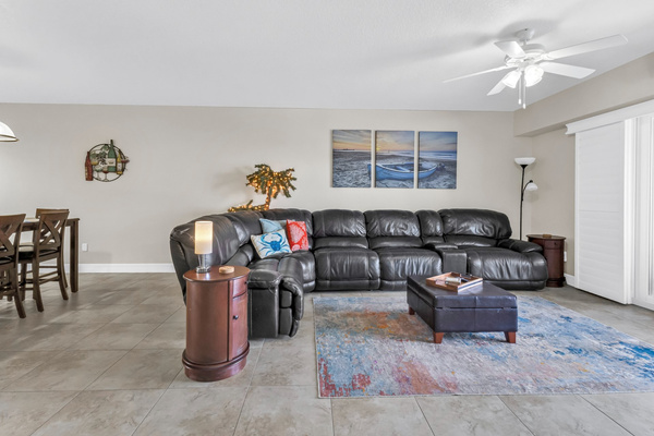  Living room has wrap around couch with 4 recliners, 2 are electric. End tables, smart plugs, 65 inch Smart TV
