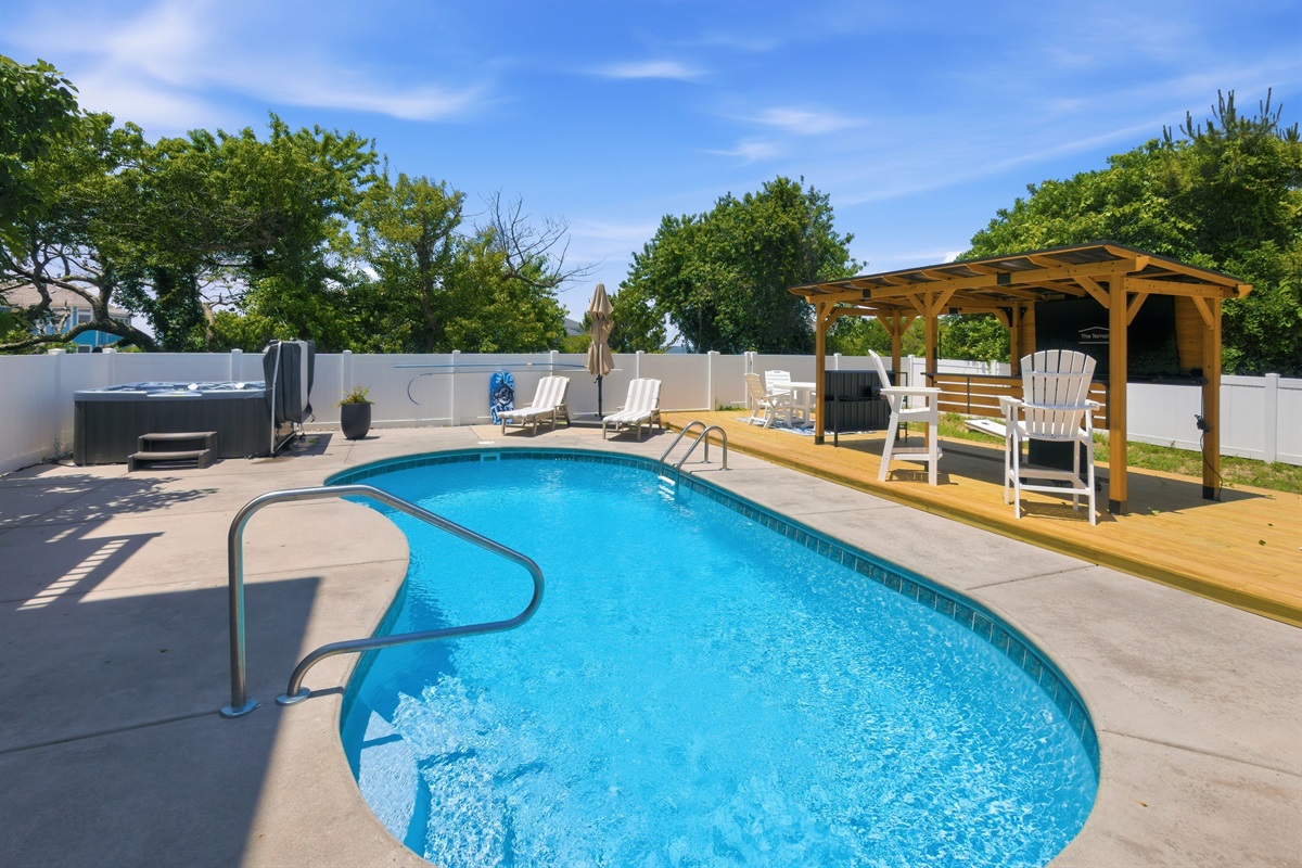 Relaxing private pool with spacious deck and shaded pergola seating