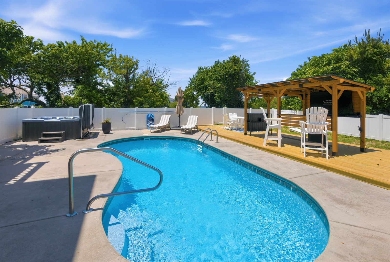 Relaxing private pool with spacious deck and shaded pergola seating