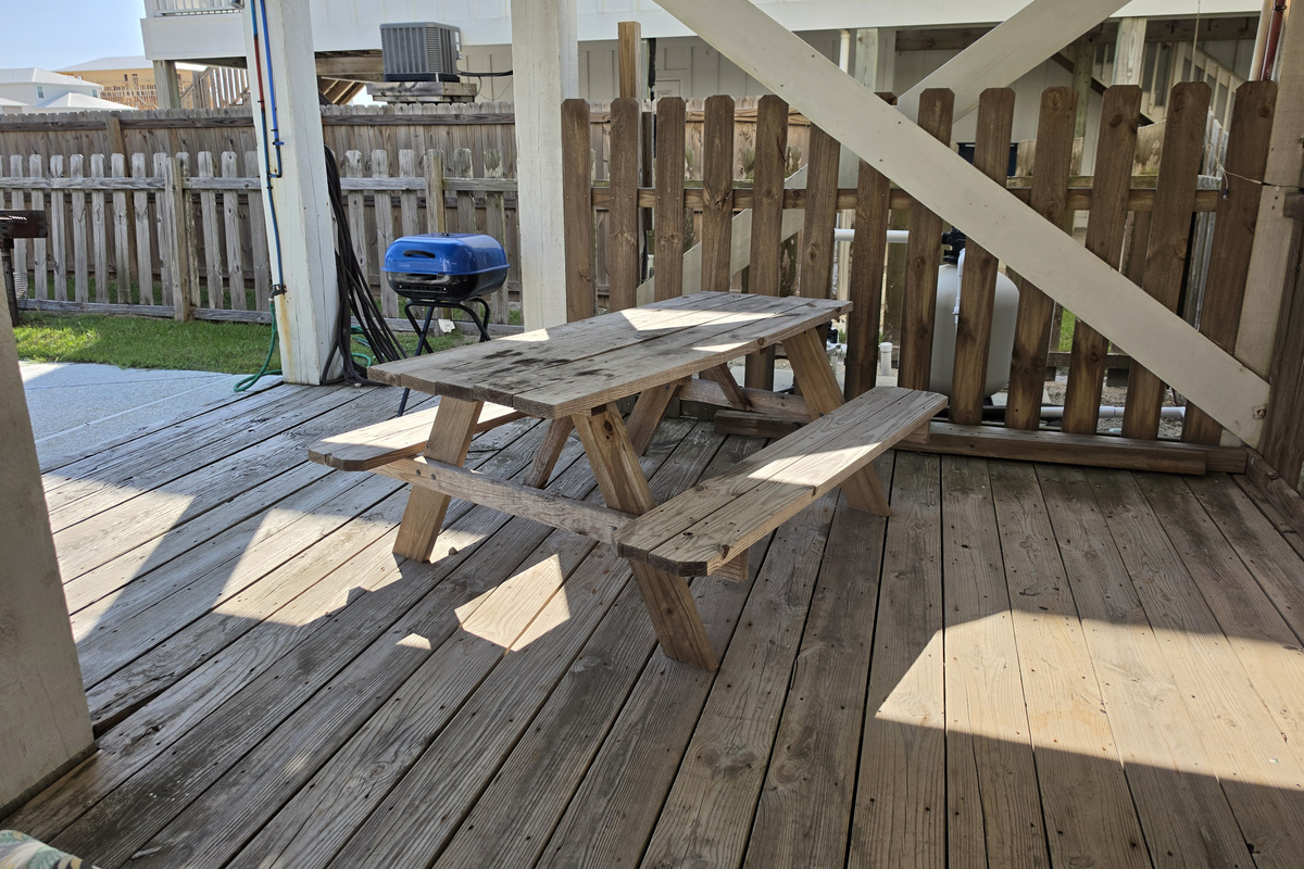 Picnic table and grill on the covered ground-level deck