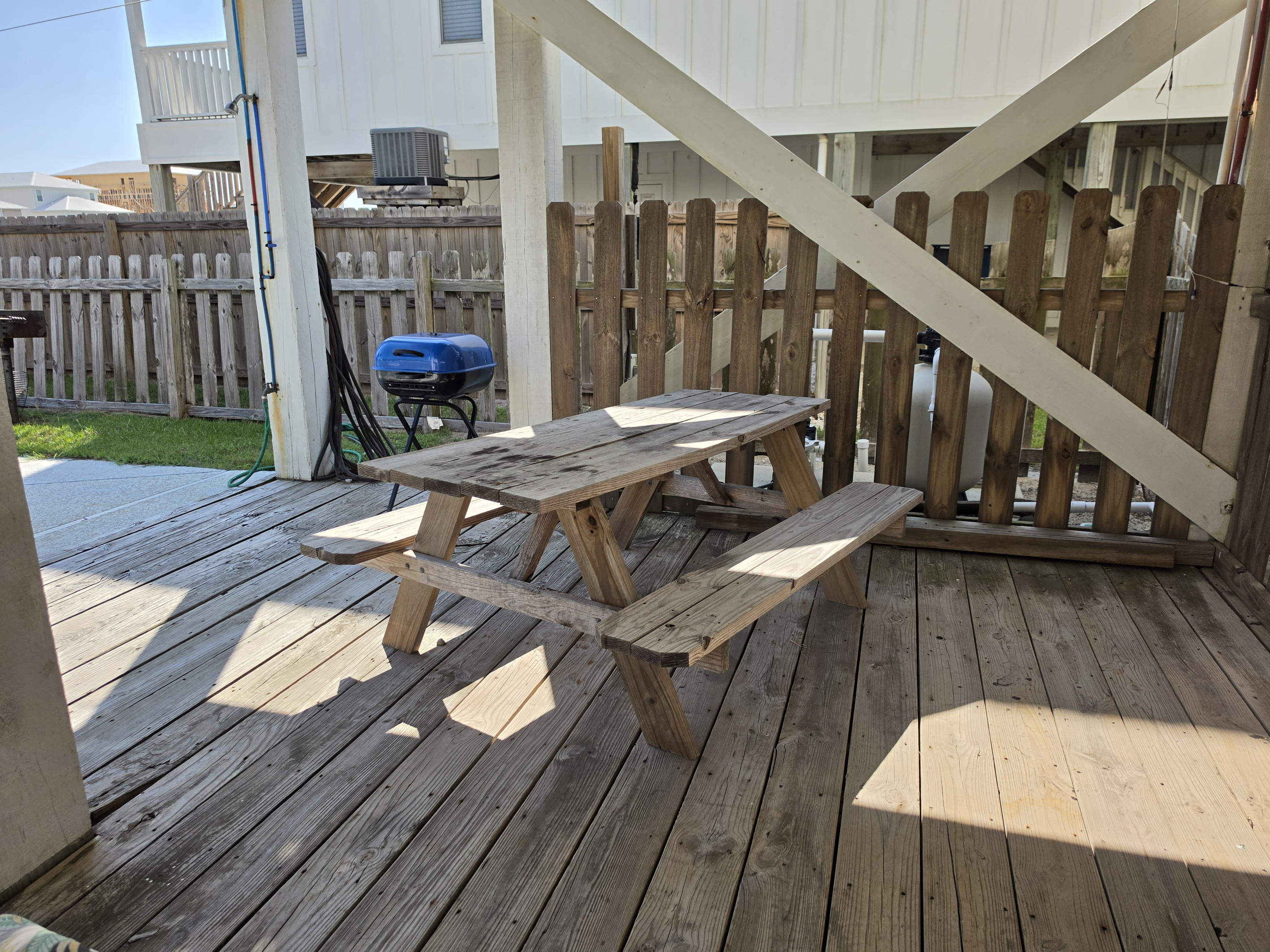 Picnic table and grill on the covered ground-level deck