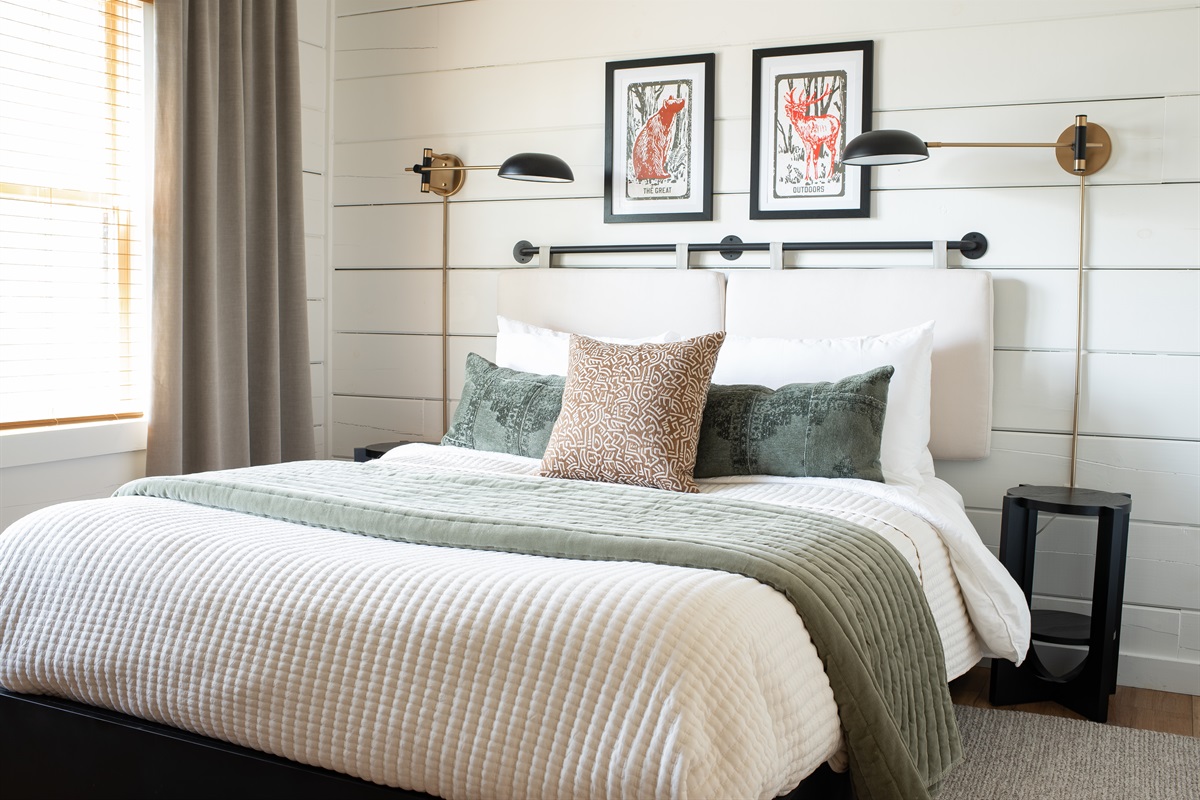 A closer view reveals soft textures, pretty accents, and the kind of bedding that just invites you to flop down and relax.