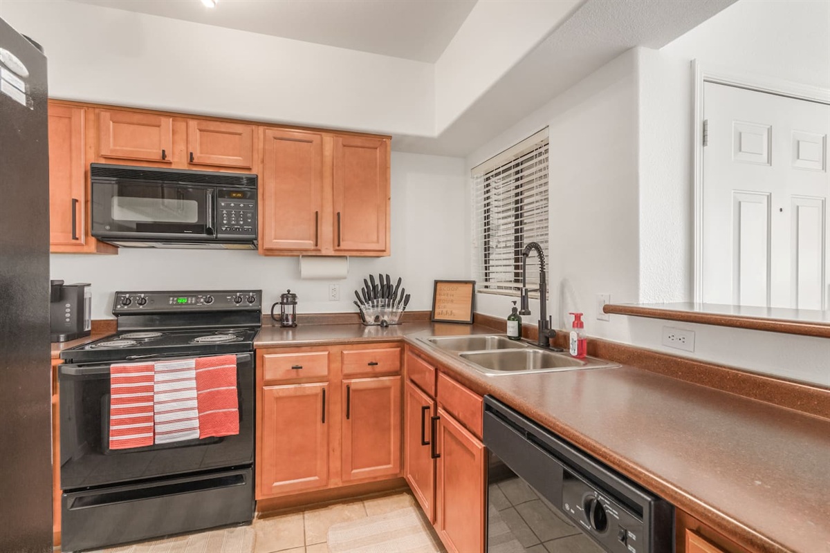   Kitchen with full-size fridge, stove, dishwasher, and plenty of counter space for daily use