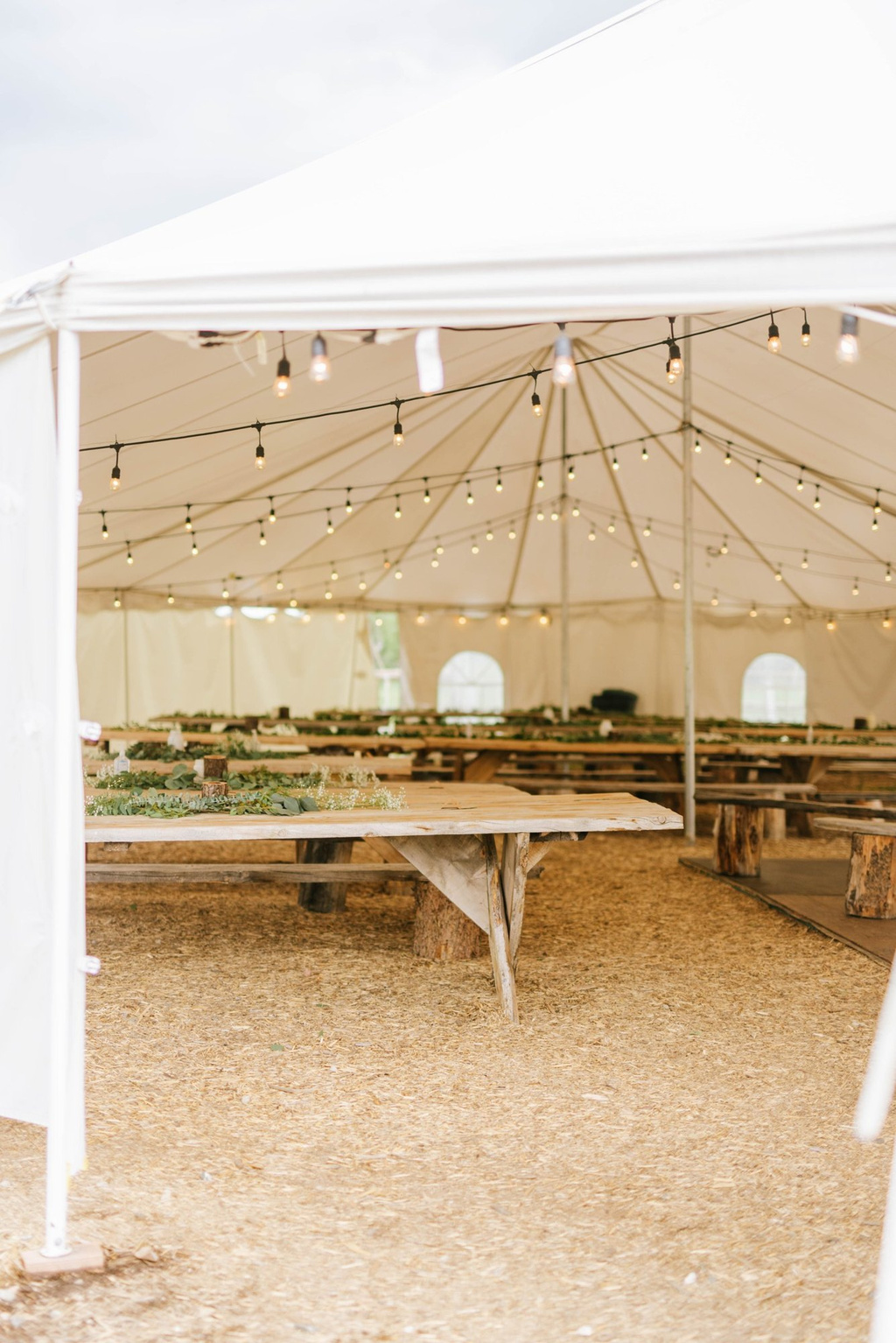 Inside the reception tent with string lights