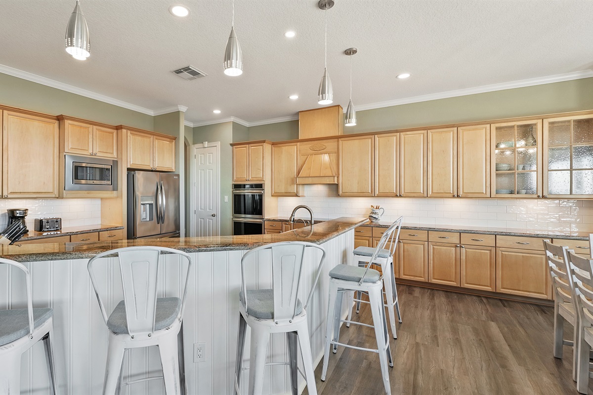 Gourmet kitchen with premium appliances and ample counter space - ideal for preparing family feasts or quick beach snacks.