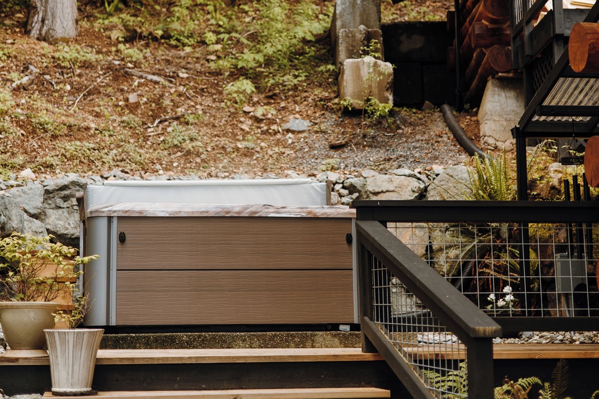 Hot tub on the back porch with a lake view.