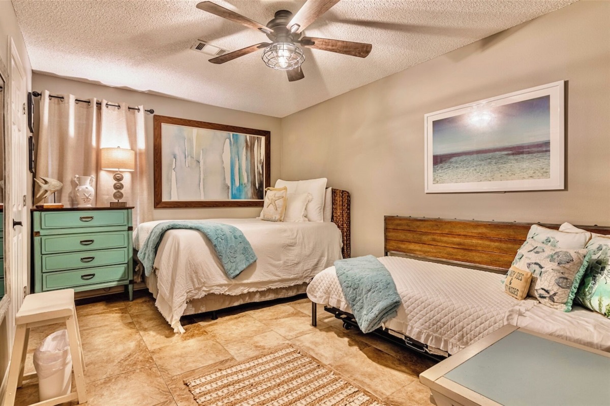 Guest bedroom with ceiling fan, smart TV, and ensuite bathroom